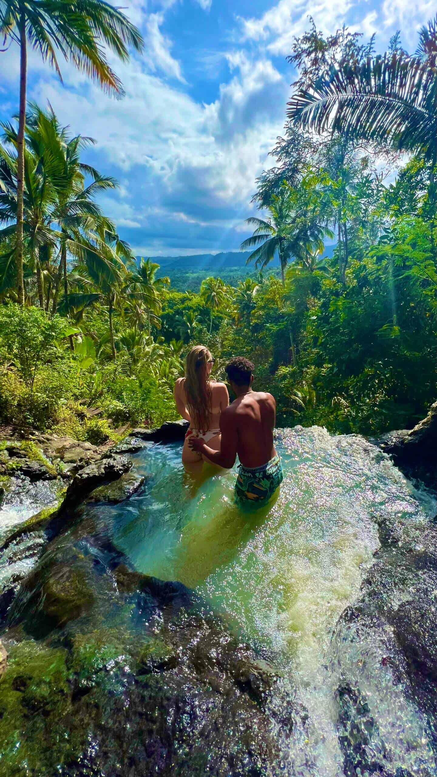 Beth and Denz at Gembleng Waterfall in Bali. Part of a Travel blog and travel blog showing the best things to do around the world.