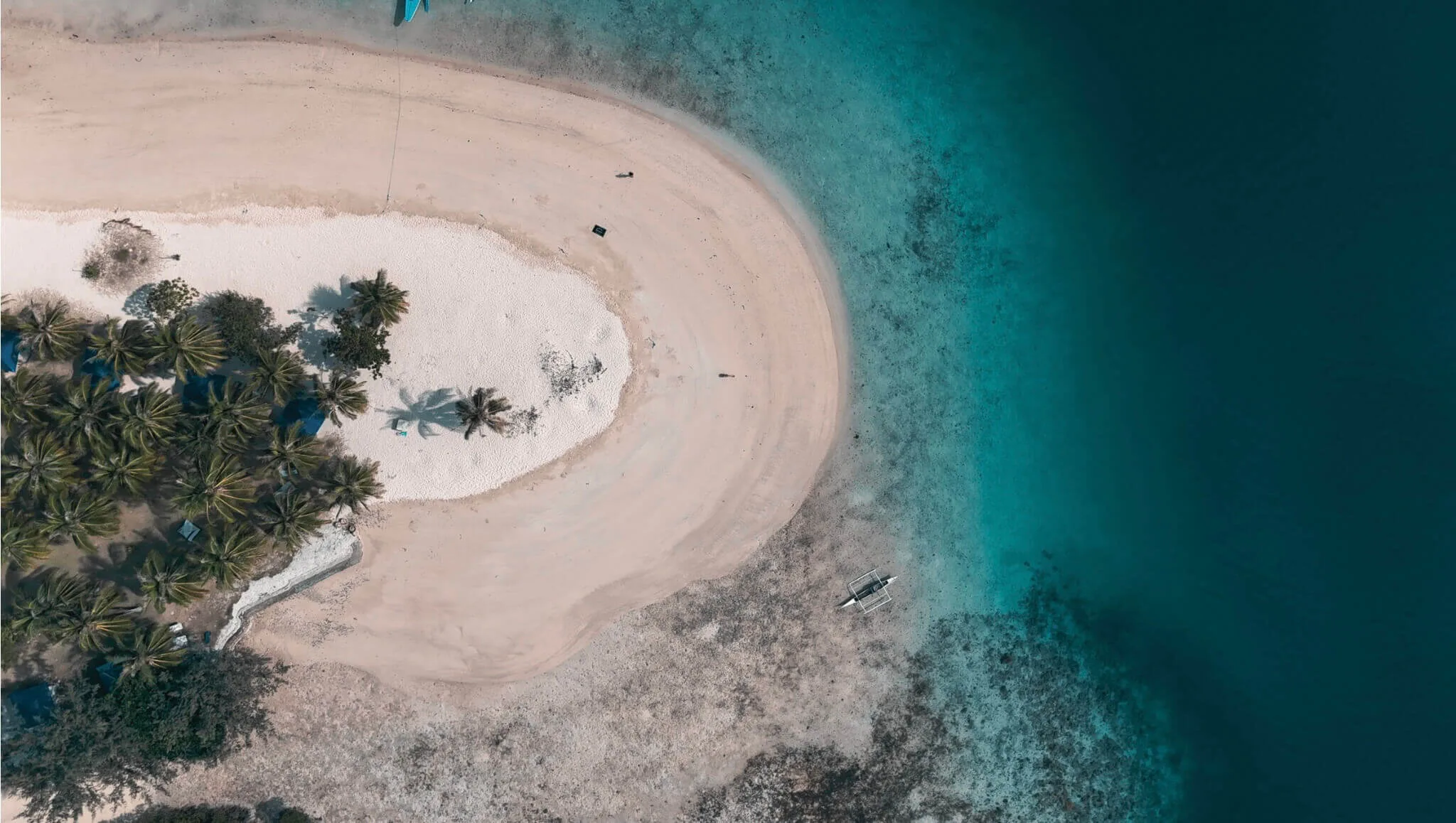 A birds eye drone picture of Pass Island, Coron, Philippines. Part of a travel guide and travel blog on what to do in the Philippines.