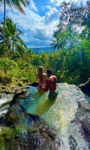 Beth and Denz at Gembleng Waterfall in Bali. Part of a Travel blog and travel blog showing the best things to do around the world.